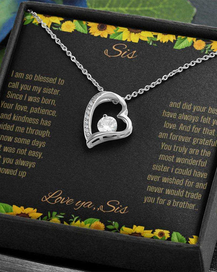 Forever Love Necklace with a white gold charm on a To Sis from Sis greeting card close up in a two-tone box angled to the right