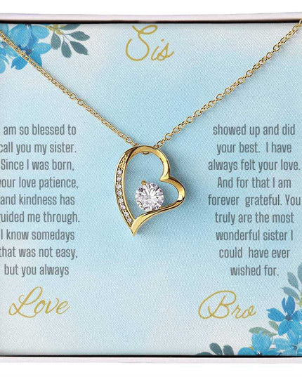 Forever Love Necklace with a yellow gold variant on a to sis from bro greeting card close up view in a two-tone box.