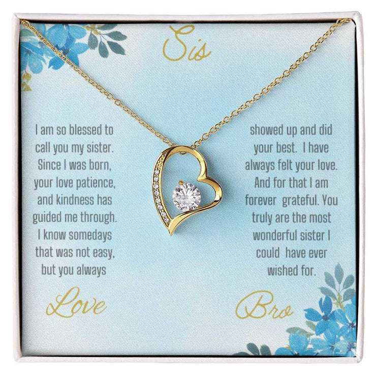 Forever Love Necklace with a yellow gold variant on a to sis from bro greeting card close up view in a two-tone box.