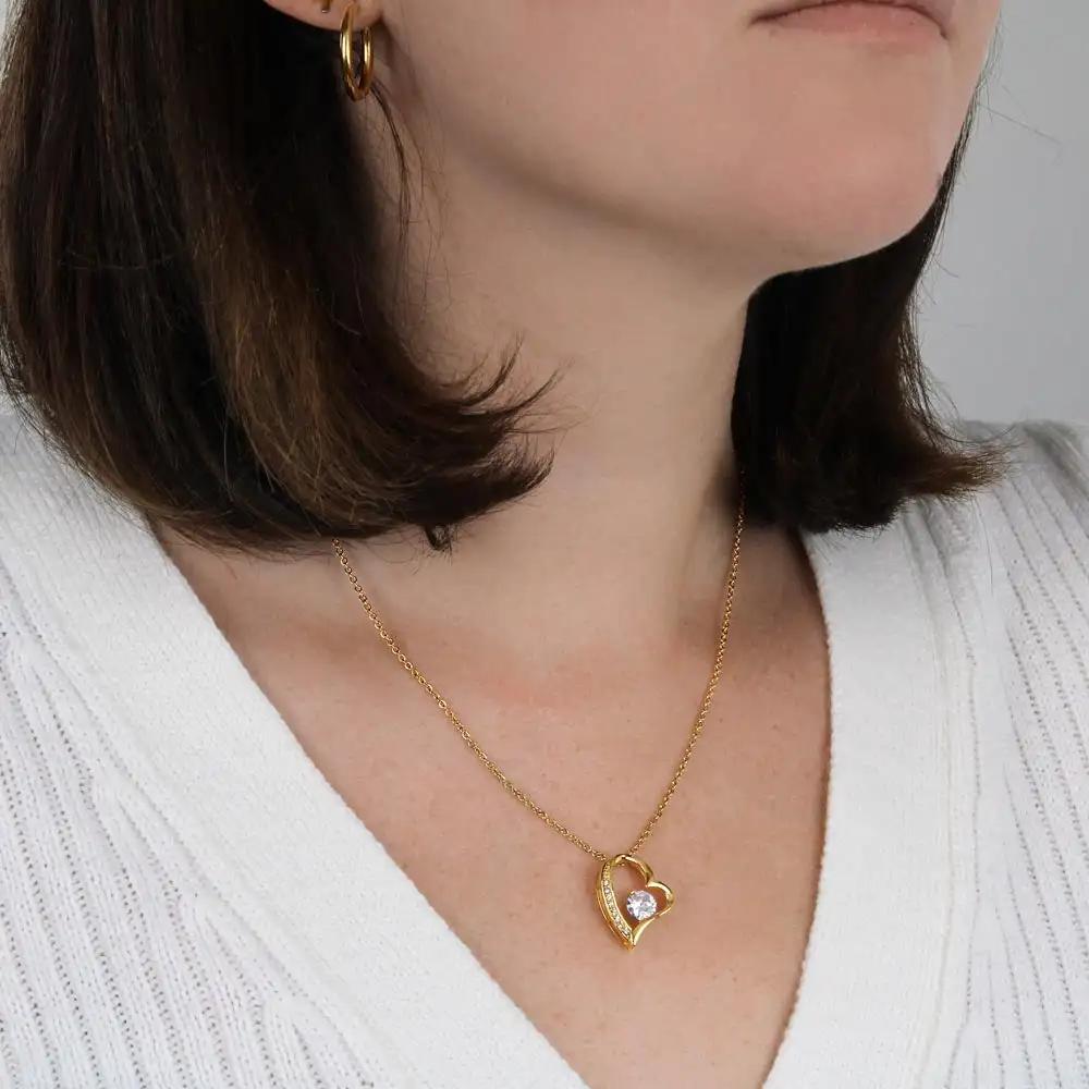 yellow gold forever love necklace on a model's neck