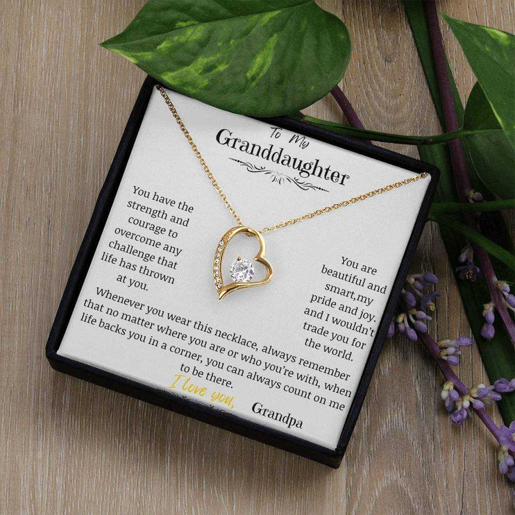 a yellow gold forever love necklace up close in a two-tone box
