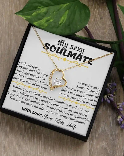 a yellow gold forever love necklace in a two-tone box