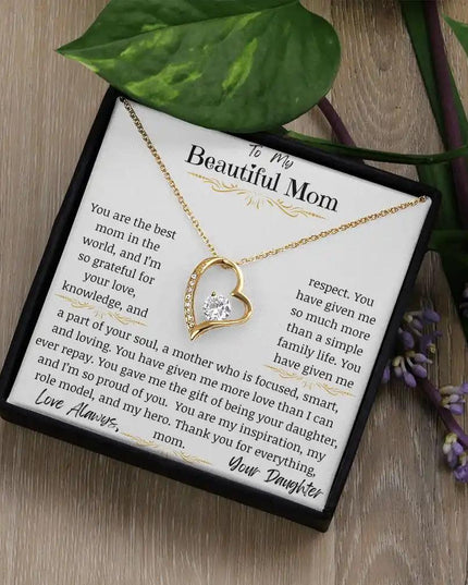 a yellow gold forever love necklace up close on table