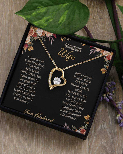 A yellow gold Forever Love Necklace on a to wife greeting card in a two-tone box on a table.