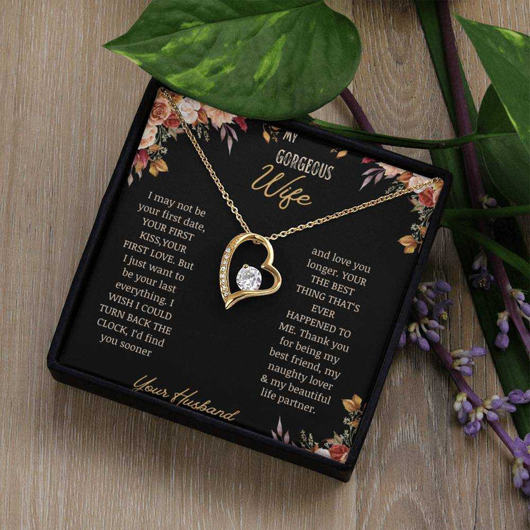 A yellow gold Forever Love Necklace on a to wife greeting card in a two-tone box on a table.