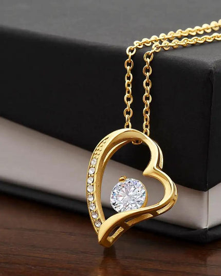 yellow gold forever love necklace on top of two-tone box