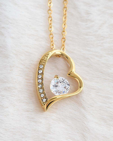 gold forever love necklace up close on a white felt fabric