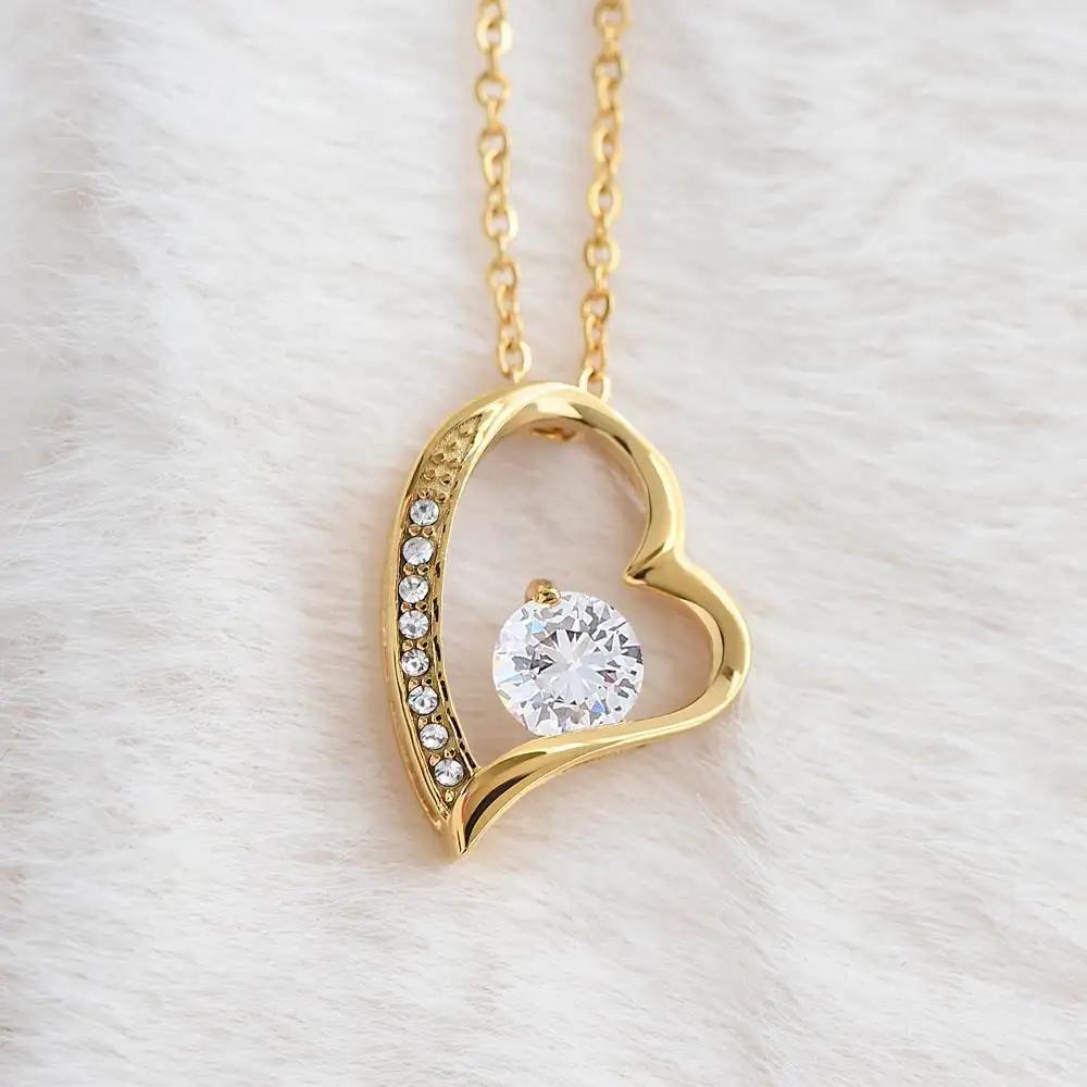 yellow gold forever love necklace on a white fleece