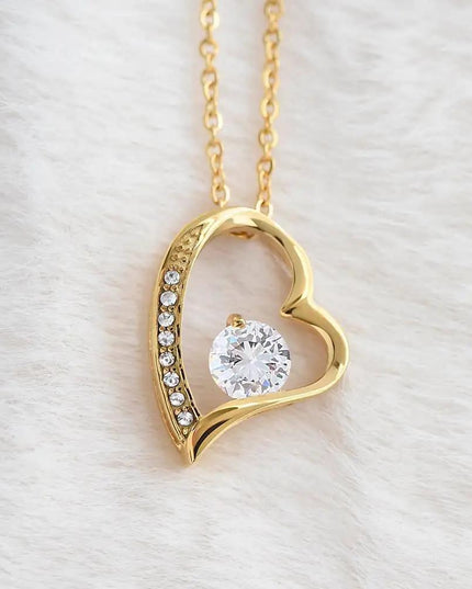 yellow gold forever love necklace on a white fleece
