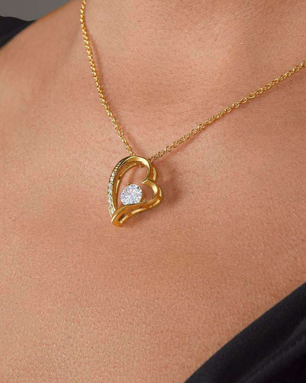 yellow gold forever love necklace on a model's neck
