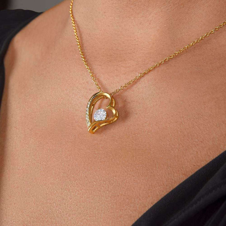 yellow gold forever love necklace on a model's neck