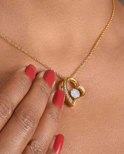 yellow gold forever love necklace on a model's neck