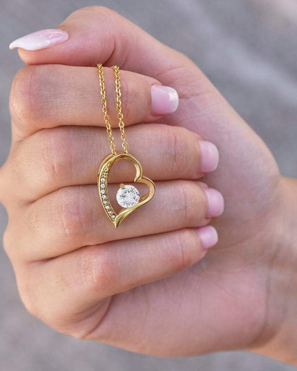 yellow gold forever love necklace in model's hand