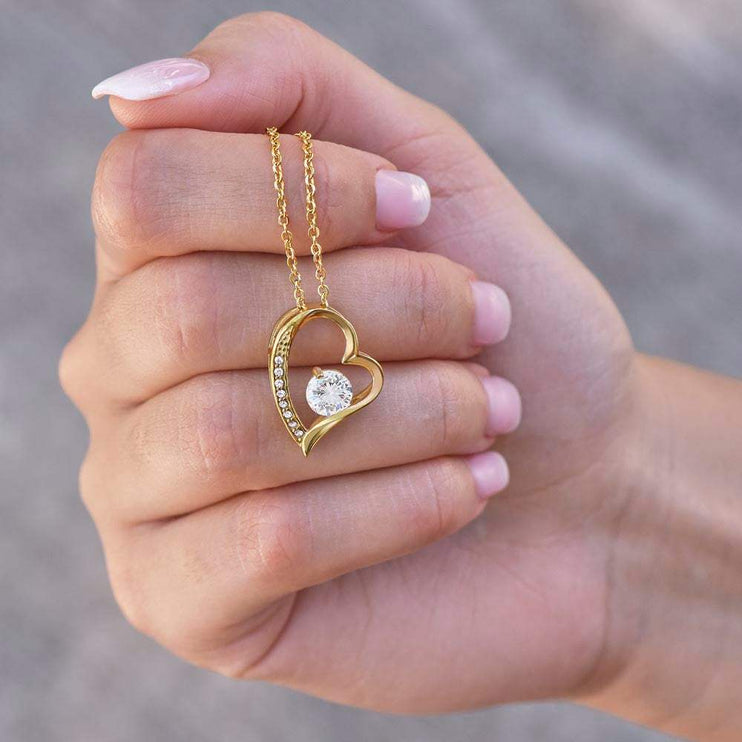 yellow gold forever love necklace in model's hand