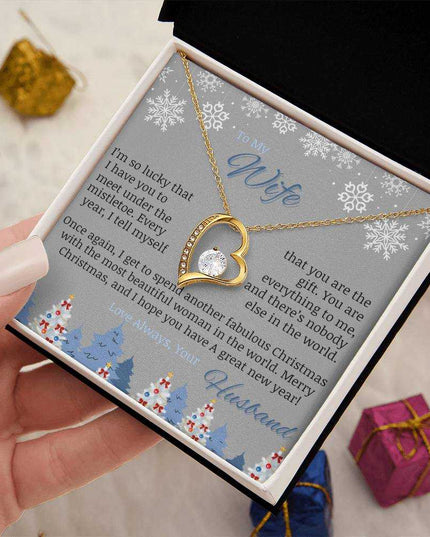 yellow gold forever love necklace in soft box in model's hand