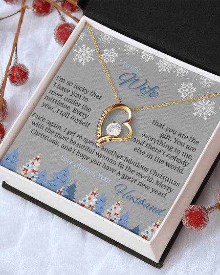 yellow gold forever love necklace in soft box on table angled right
