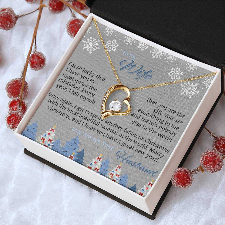 yellow gold forever love necklace in soft box on table angled right