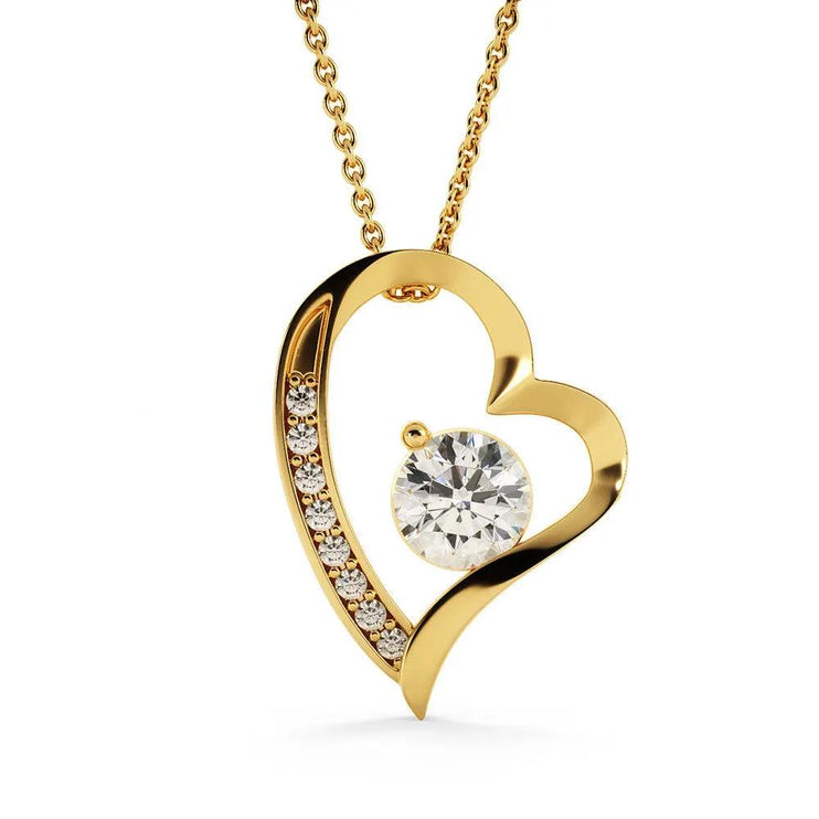 yellow gold forever love necklace hanging on white backdrop