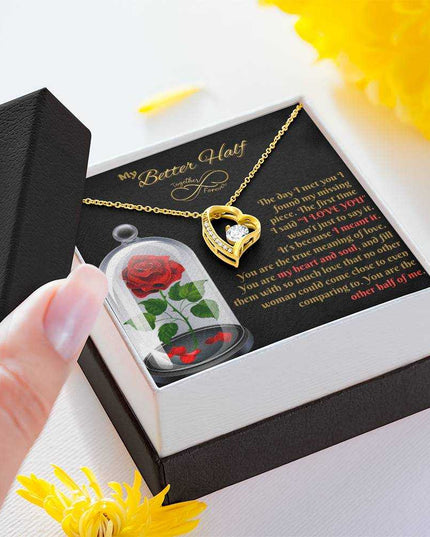 yellow gold forever love necklace in a soft box with lid in hand of a model