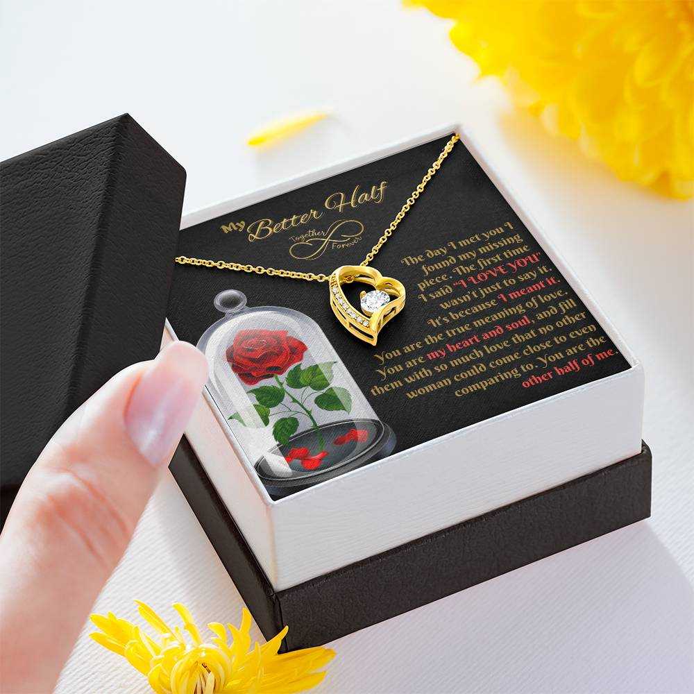 yellow gold forever love necklace in a soft box with lid in hand of a model