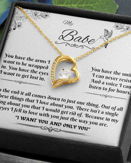 yellow gold forever love necklace in a soft box angled to the left