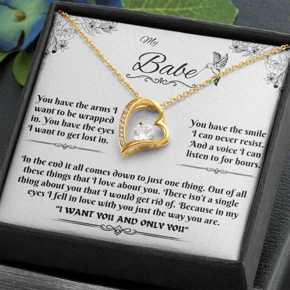 yellow gold forever love necklace in a soft box angled to the left