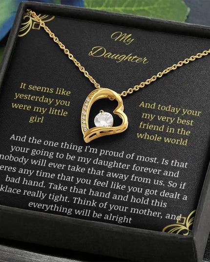 Forever Love Necklace with a yellow gold charm in a two-tone box with a to daughter from mom greeting card close up angled to left
