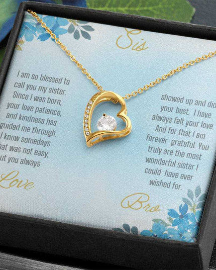 Forever Love Necklace with a yellow gold variant on a to sis from bro greeting card close up view in a two-tone box angled slightly to the right.