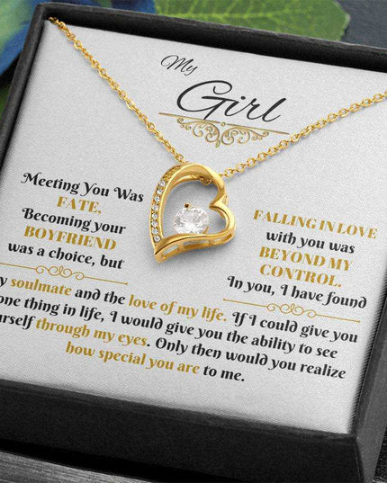 gold forever love necklace in a soft box angled to the left