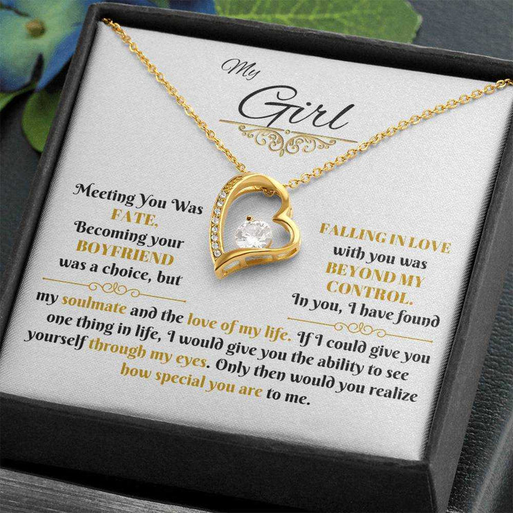 gold forever love necklace in a soft box angled to the left