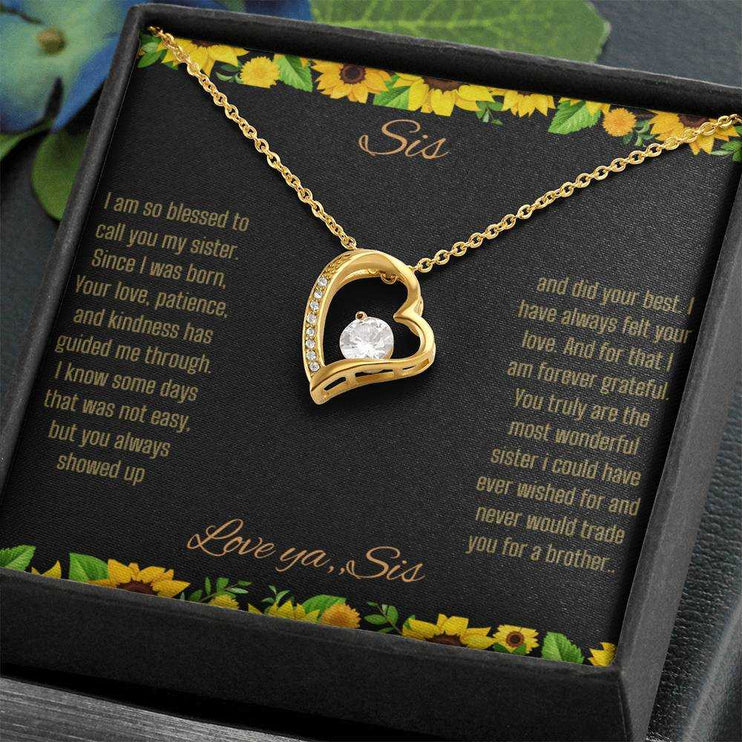 Forever Love Necklace with a yellow gold charm on a To Sis from Sis greeting card up close angled slightly to right in a two-tone box