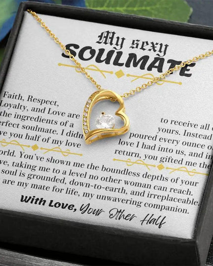 a yellow gold forever love necklace up close in a two-tone box
