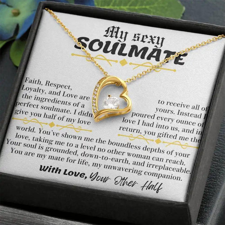 a yellow gold forever love necklace up close in a two-tone box